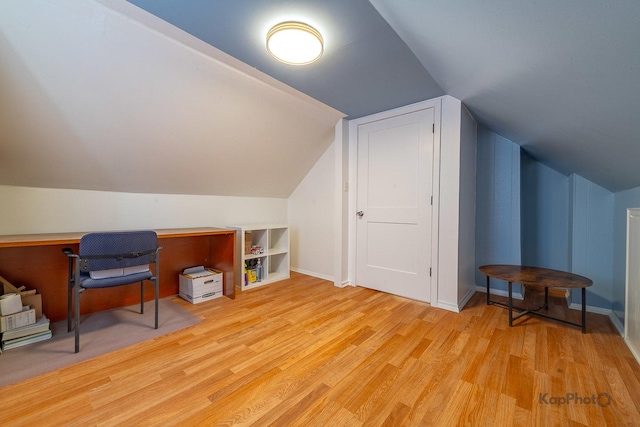 bonus room featuring wood finished floors and vaulted ceiling