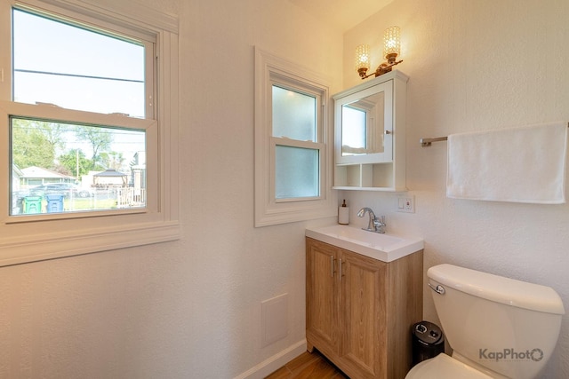 half bathroom with toilet and vanity