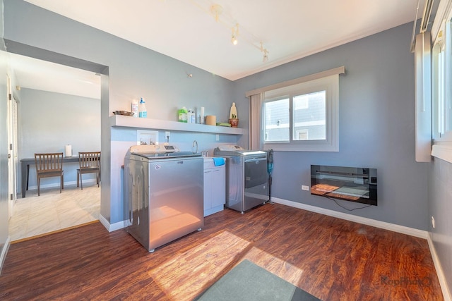 laundry room with independent washer and dryer, dark wood finished floors, baseboards, and wet bar