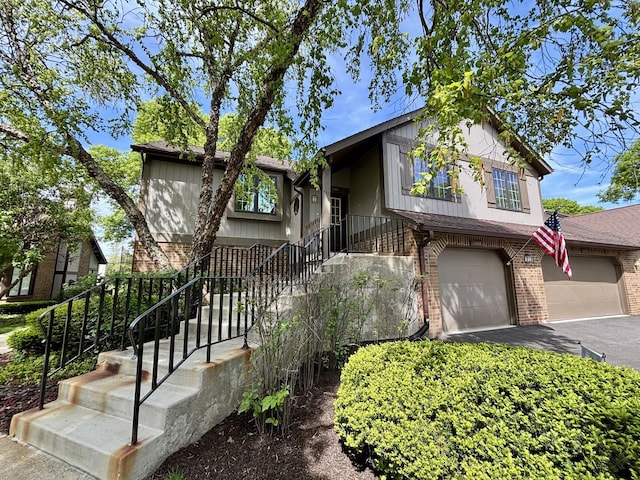 13464 S Westview Dr Unit 4, Palos Heights, IL 60463 - view of front of house featuring brick siding, a garage, asphalt driveway, and stairs