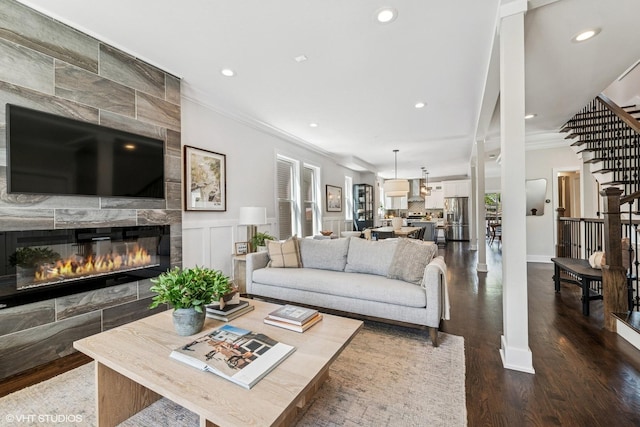 4328 N Ridgeway Ave, Chicago, IL 60618 - living area with crown molding, stairs, dark wood-style flooring, recessed lighting, and a tile fireplace