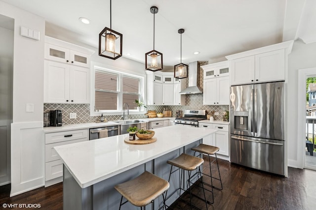 4328 N Ridgeway Ave, Chicago, IL 60618 - kitchen featuring stainless steel appliances, a sink, wall chimney exhaust hood, a breakfast bar, and tasteful backsplash