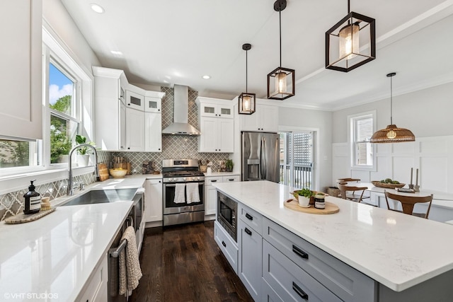 4328 N Ridgeway Ave, Chicago, IL 60618 - kitchen with appliances with stainless steel finishes, wall chimney range hood, dark wood-style flooring, backsplash, and pendant lighting