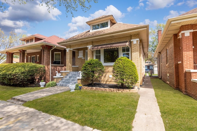 8109 S Marquette Ave, Chicago, IL 60617 - bungalow-style home with brick siding, a front lawn, a porch, and a shingled roof