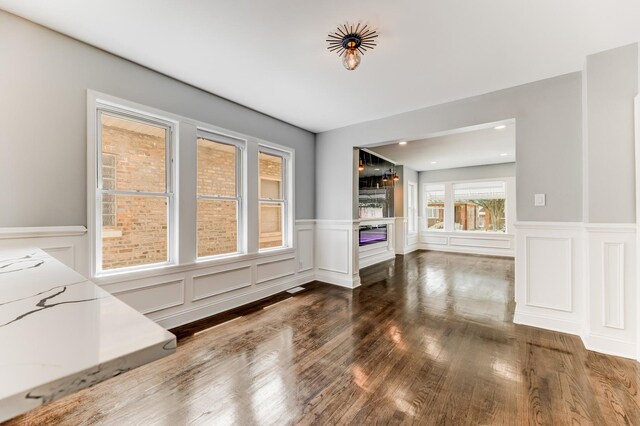 8109 S Marquette Ave, Chicago, IL 60617 - unfurnished dining area with a wainscoted wall, wood finished floors, a decorative wall, and recessed lighting
