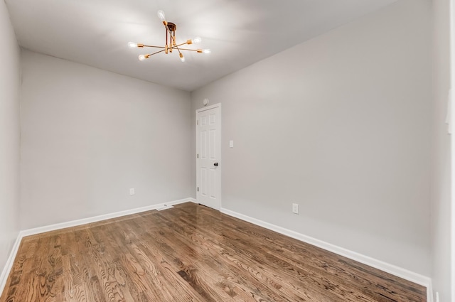 8109 S Marquette Ave, Chicago, IL 60617 - unfurnished room featuring a chandelier, baseboards, and wood finished floors