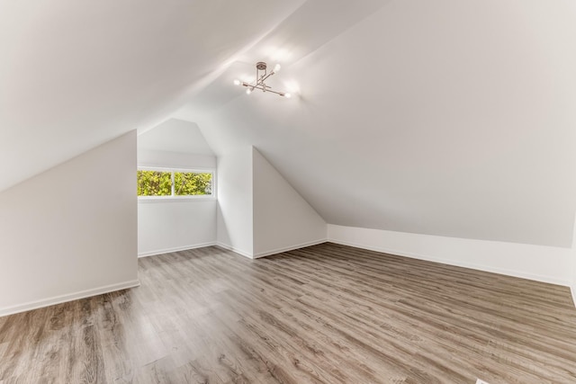 8109 S Marquette Ave, Chicago, IL 60617 - bonus room featuring wood finished floors, vaulted ceiling, a chandelier, and baseboards