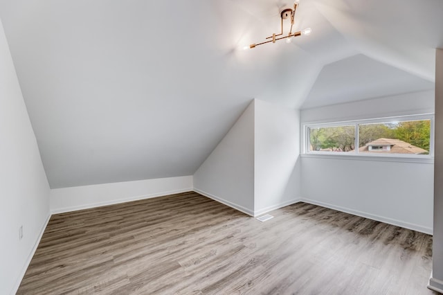 8109 S Marquette Ave, Chicago, IL 60617 - additional living space featuring vaulted ceiling, wood finished floors, and baseboards