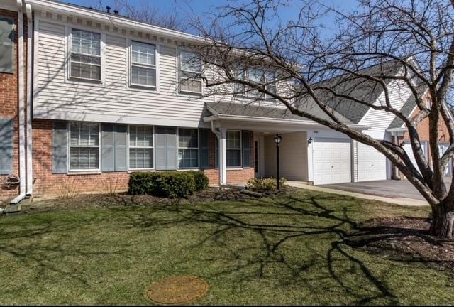 803 Persimmon Ln Unit A, Mount Prospect, IL 60056 - view of front of property with brick siding, driveway, a front lawn, and an attached garage