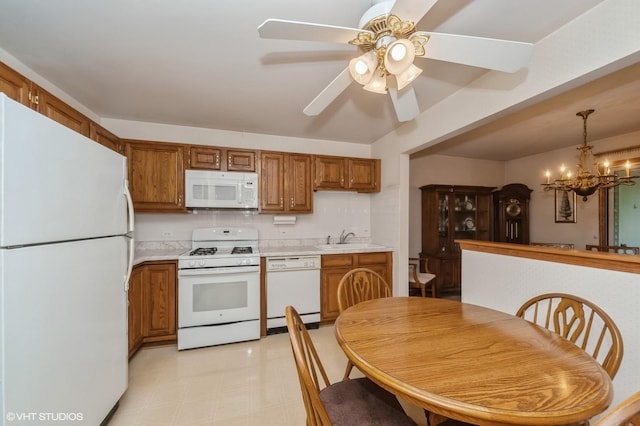 803 Persimmon Ln Unit A, Mount Prospect, IL 60056 - kitchen with white appliances, a sink, brown cabinetry, light countertops, and a chandelier