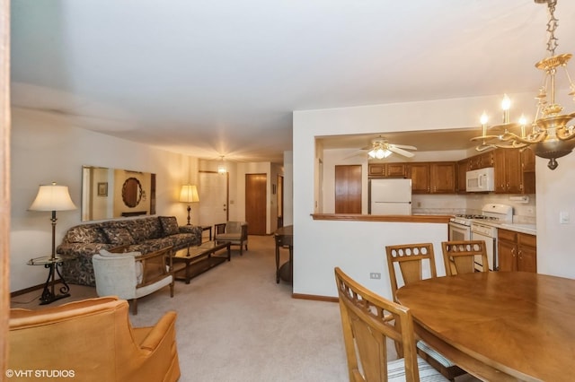 803 Persimmon Ln Unit A, Mount Prospect, IL 60056 - dining area featuring light carpet, ceiling fan, a chandelier, and baseboards