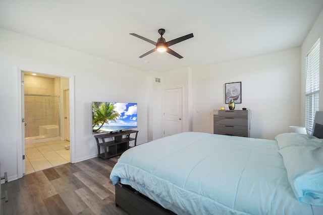 bedroom with wood finished floors, connected bathroom, and ceiling fan