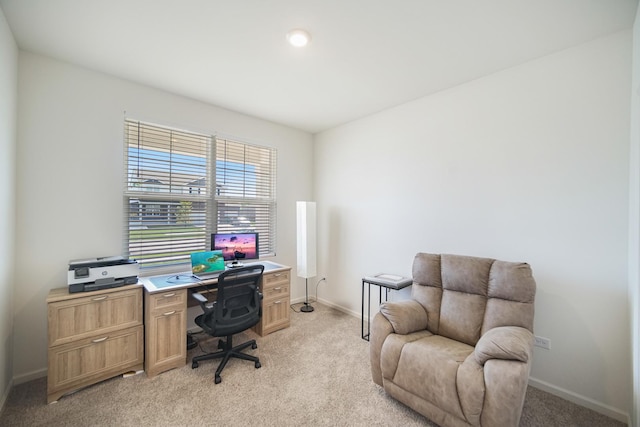 office area featuring light colored carpet and baseboards