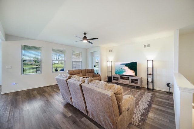 living area featuring ceiling fan, dark wood finished floors, and baseboards