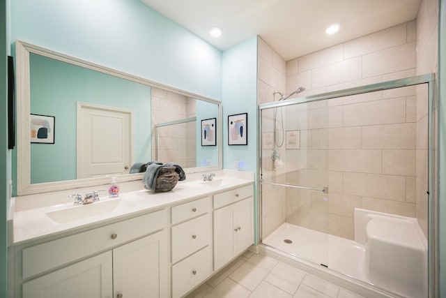 full bathroom featuring a stall shower, tile patterned flooring, double vanity, and recessed lighting