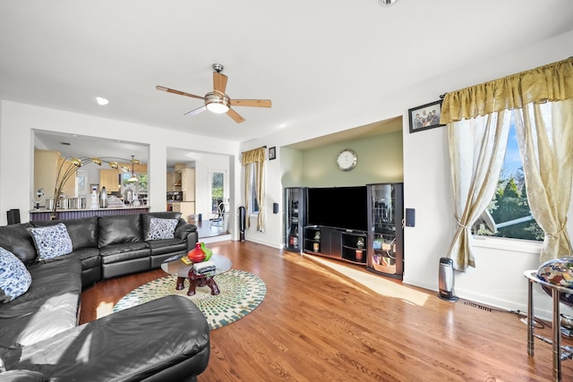 living area with ceiling fan and wood finished floors