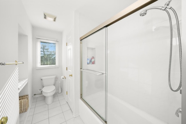 bathroom with toilet, tile patterned flooring, and shower / bath combination with glass door