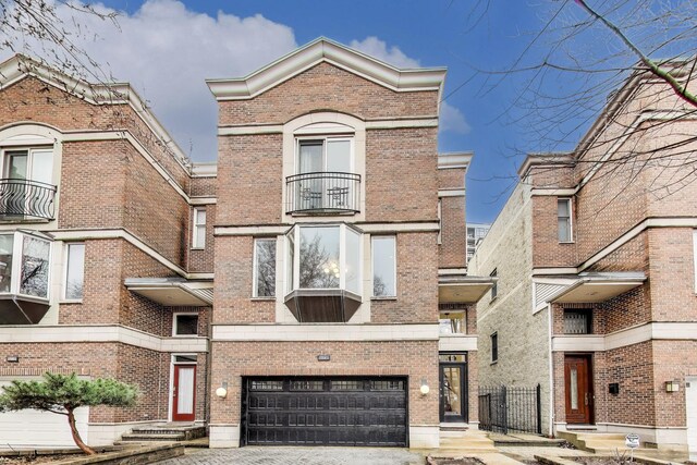 19 W 15th St, Chicago, IL 60605 - view of front of property with an attached garage, brick siding, and driveway
