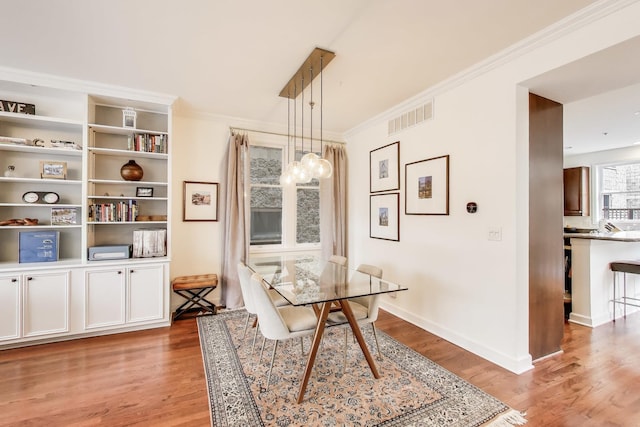 19 W 15th St, Chicago, IL 60605 - dining area with light wood-type flooring, ornamental molding, and a chandelier