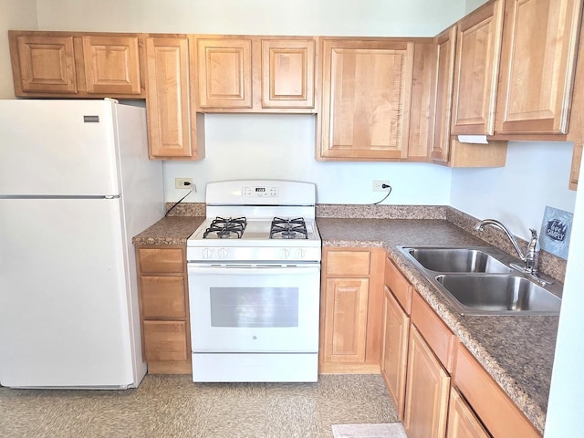 kitchen featuring white appliances, a sink, dark countertops, and light brown cabinets