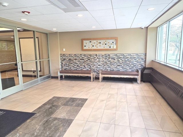 common area featuring a drop ceiling, recessed lighting, and a security system