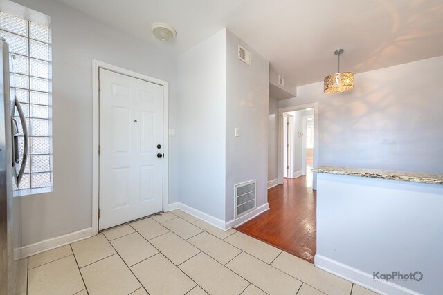 4006 W Nelson St Unit 6A, Chicago, IL 60641 - foyer entrance featuring plenty of natural light, baseboards, and light tile patterned floors