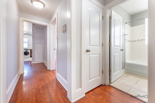 4006 W Nelson St Unit 6A, Chicago, IL 60641 - hall featuring washer / dryer, wood finished floors, and baseboards