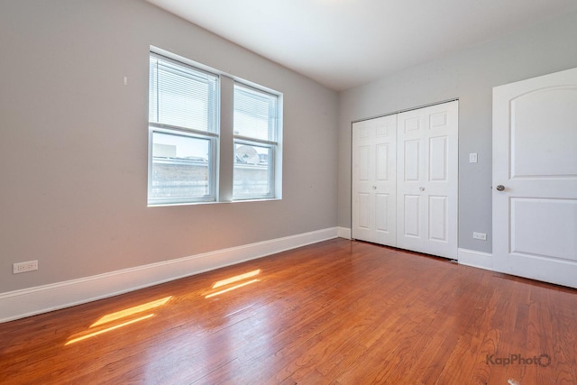 4006 W Nelson St Unit 6A, Chicago, IL 60641 - unfurnished bedroom with wood finished floors, baseboards, and a closet