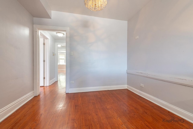 4006 W Nelson St Unit 6A, Chicago, IL 60641 - empty room with baseboards, wood finished floors, and a chandelier