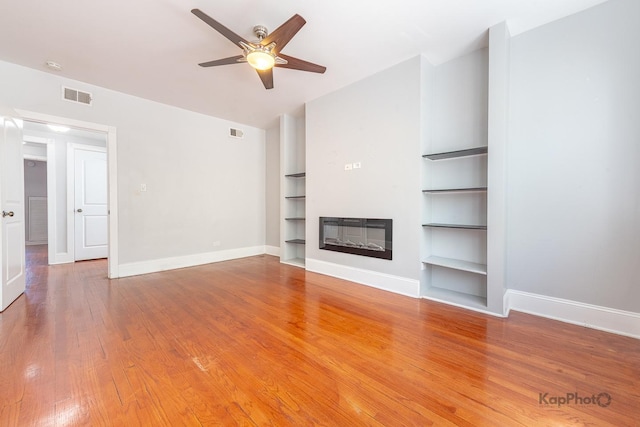 4006 W Nelson St Unit 6A, Chicago, IL 60641 - unfurnished living room with baseboards, built in features, wood finished floors, and a ceiling fan
