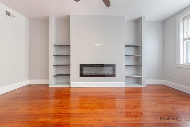 4006 W Nelson St Unit 6A, Chicago, IL 60641 - unfurnished living room featuring wood finished floors, baseboards, a glass covered fireplace, and ceiling fan