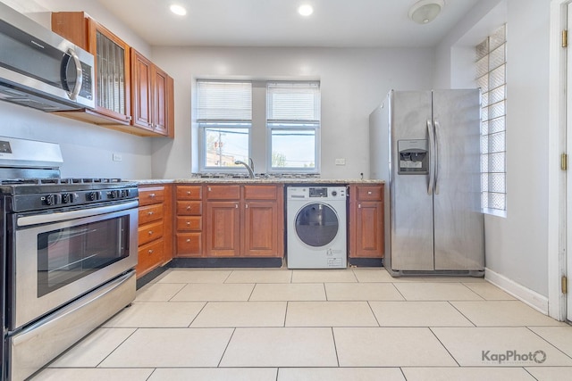 4006 W Nelson St Unit 6A, Chicago, IL 60641 - kitchen featuring washer / dryer, appliances with stainless steel finishes, light stone countertops, recessed lighting, and brown cabinets