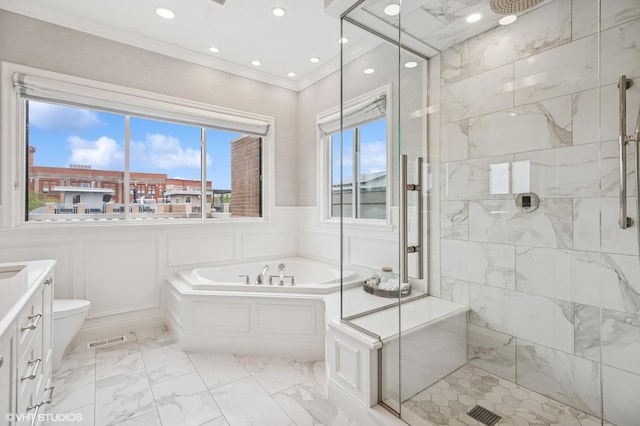 bathroom featuring a stall shower, plenty of natural light, a garden tub, ornamental molding, and vanity