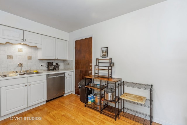 1313B S Rebecca Rd Unit 215, Lombard, IL 60148 - kitchen with stainless steel dishwasher, a sink, backsplash, light wood finished floors, and light countertops