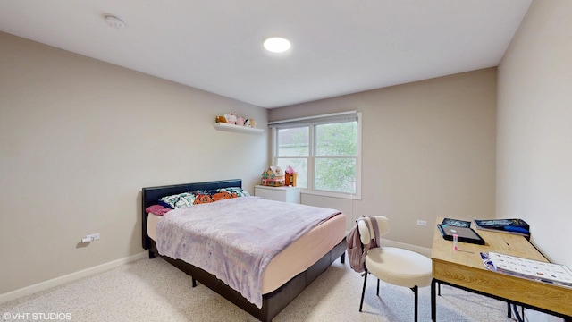 bedroom featuring baseboards and light carpet