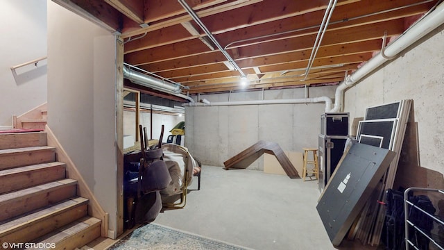 unfinished basement featuring stairway