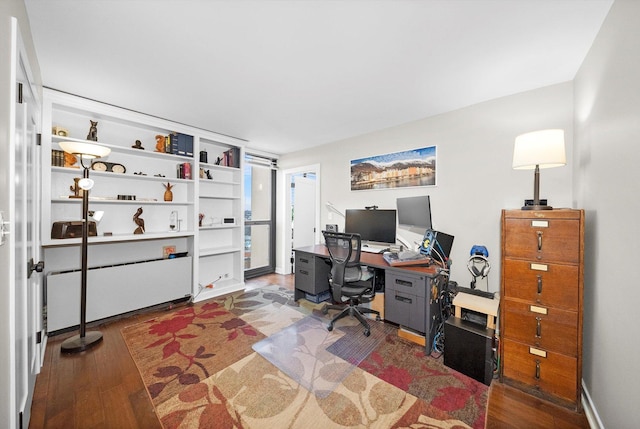 office space featuring wood finished floors and radiator heating unit