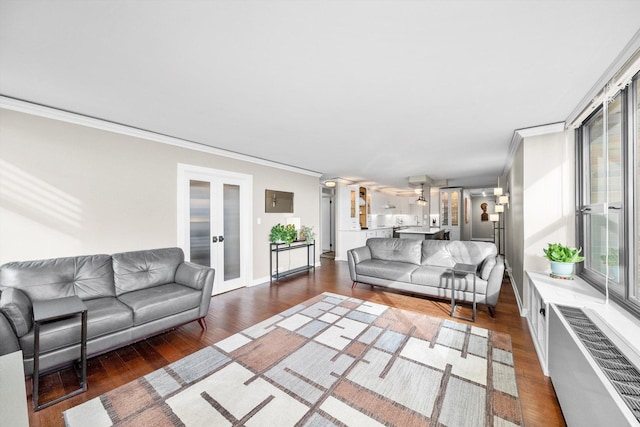 living area with crown molding, french doors, wood finished floors, and healthy amount of natural light