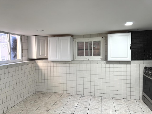 5343 W Warwick Ave, Chicago, IL 60641 - bathroom featuring tile walls, tile patterned floors, and recessed lighting