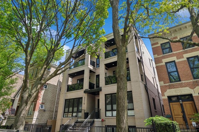 view of apartment building / complex with a fenced front yard