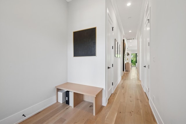 corridor with light wood-style flooring, baseboards, and recessed lighting