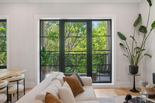 doorway to outside featuring wood finished floors and baseboards