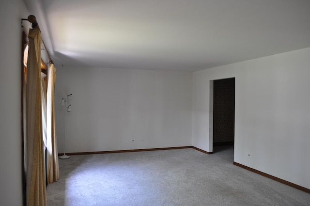carpeted spare room with baseboards