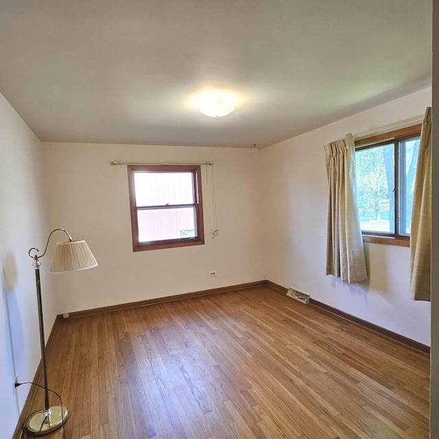 unfurnished room featuring wood finished floors and baseboards
