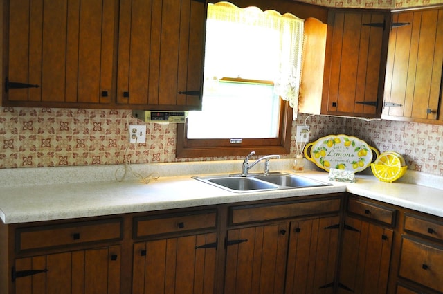 kitchen featuring a sink and light countertops