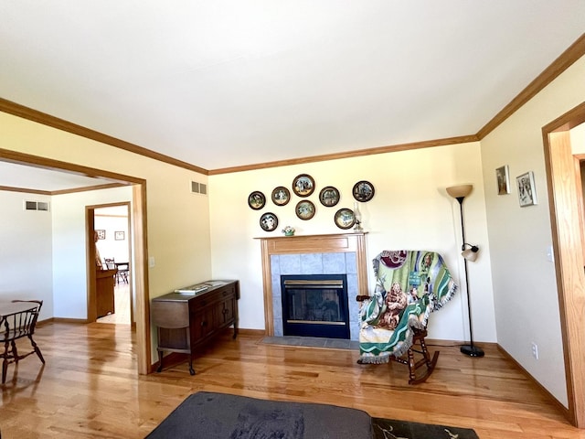 80 N 14th Rd, Lostant, IL 61334 - living area featuring wood finished floors, a tile fireplace, baseboards, and ornamental molding