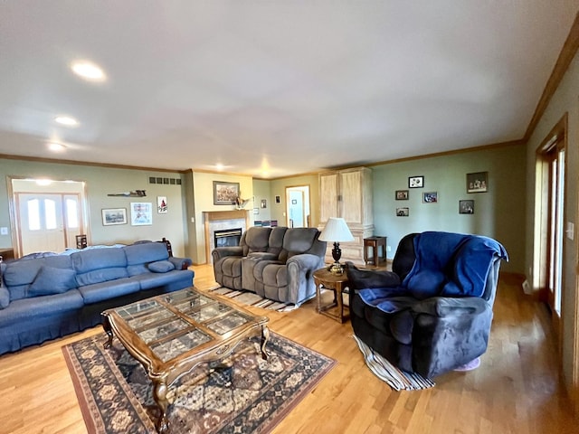 80 N 14th Rd, Lostant, IL 61334 - living area featuring ornamental molding, light wood finished floors, a tiled fireplace, and recessed lighting