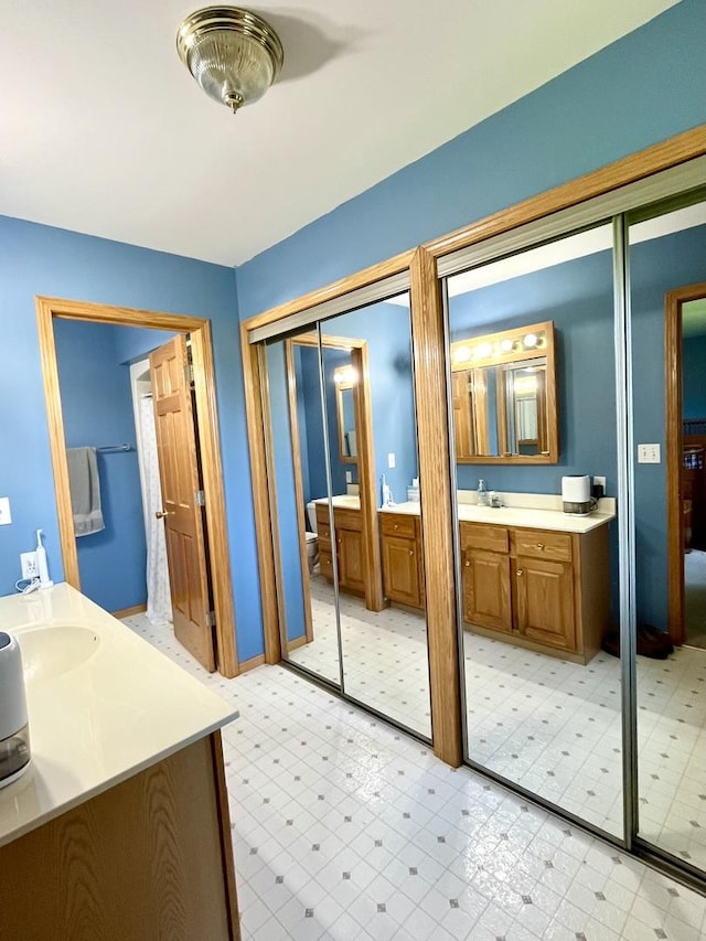 80 N 14th Rd, Lostant, IL 61334 - full bath featuring two vanities, tile patterned floors, and toilet
