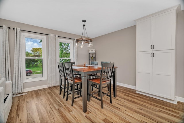 424 Falcon Ridge Way, Bolingbrook, IL 60440 - dining space featuring baseboards, light wood finished floors, and a chandelier
