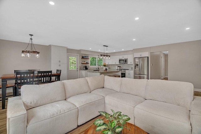 424 Falcon Ridge Way, Bolingbrook, IL 60440 - living room with light wood-style flooring, a chandelier, and recessed lighting